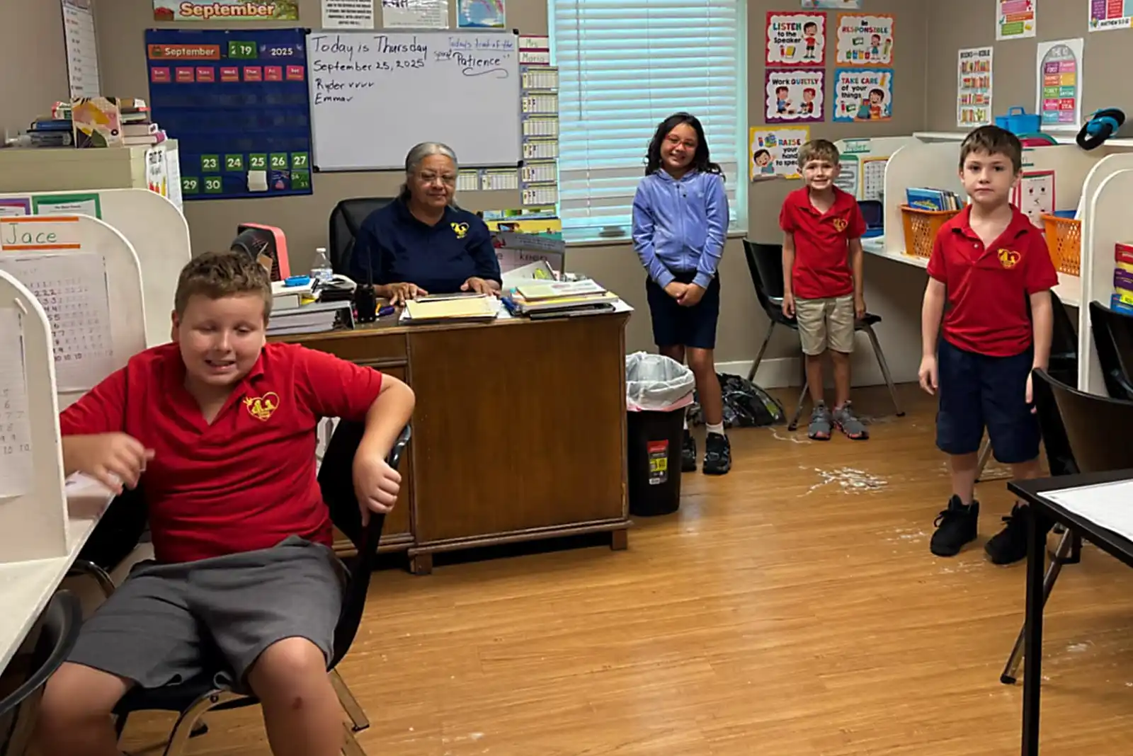 Students and teacher at Esther's School wearing custom embroidered uniforms by Dejah Embroidery